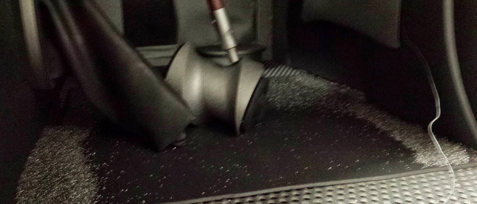 A torch working over a dark shop surface